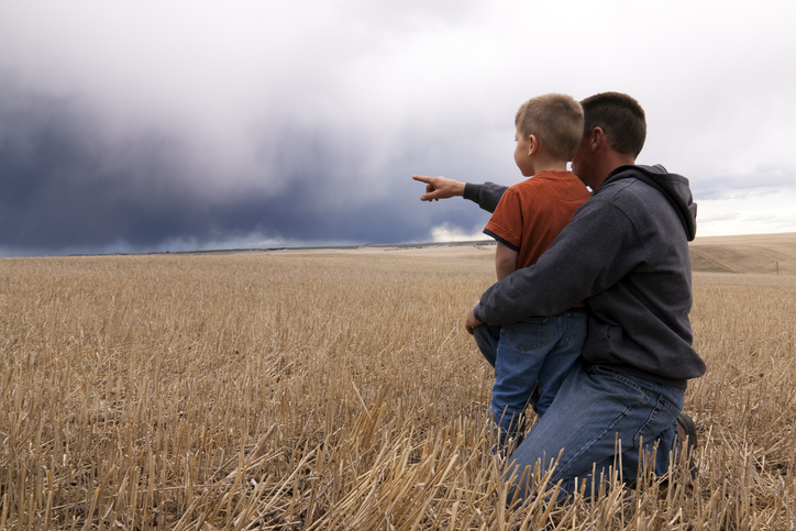 Father and son watching storm coming in